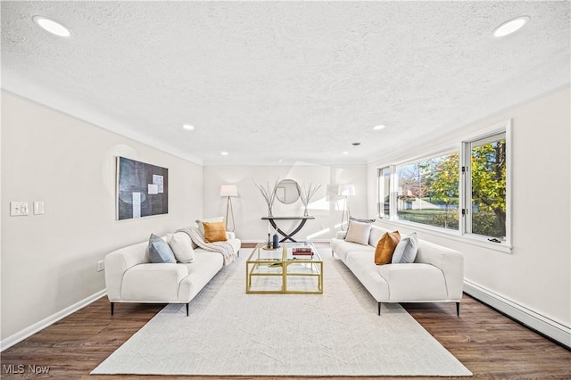 30529 Ridge Rd, Wickliffe, OH 44092 - living room with a baseboard heating unit, a textured ceiling, dark wood-style floors, and recessed lighting