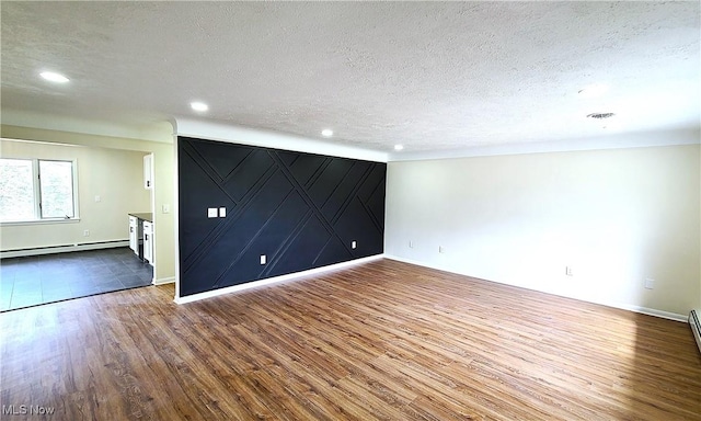 30529 Ridge Rd, Wickliffe, OH 44092 - empty room featuring wood finished floors, a baseboard heating unit, a textured ceiling, and recessed lighting