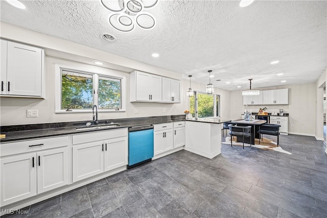 30529 Ridge Rd, Wickliffe, OH 44092 - kitchen featuring dishwashing machine, a peninsula, white cabinets, dark countertops, and a textured ceiling