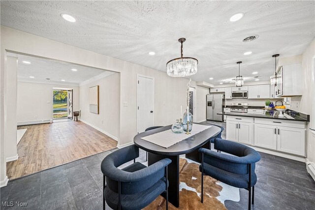 30529 Ridge Rd, Wickliffe, OH 44092 - dining space featuring recessed lighting, a chandelier, a baseboard radiator, a textured ceiling, and dark tile patterned flooring