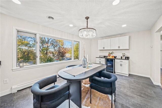 30529 Ridge Rd, Wickliffe, OH 44092 - dining area with beverage cooler, a baseboard heating unit, bar, recessed lighting, and a chandelier