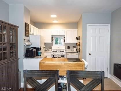 522 Lamont St, Akron, OH 44305 - kitchen featuring stove, light countertops, white cabinets, and dishwasher