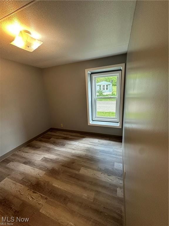 7443 Spillway Rd Unit 63, Lisbon, OH 44432 - empty room featuring wood finished floors and baseboards