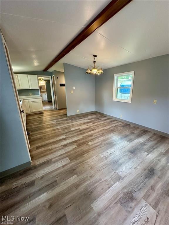 7443 Spillway Rd Unit 63, Lisbon, OH 44432 - unfurnished living room with a chandelier and wood finished floors