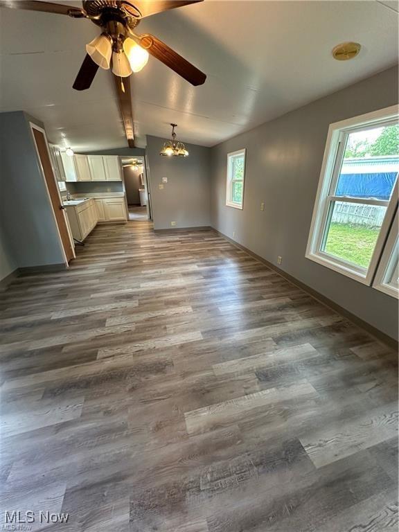 7443 Spillway Rd Unit 63, Lisbon, OH 44432 - unfurnished living room with wood finished floors, ceiling fan, and a chandelier