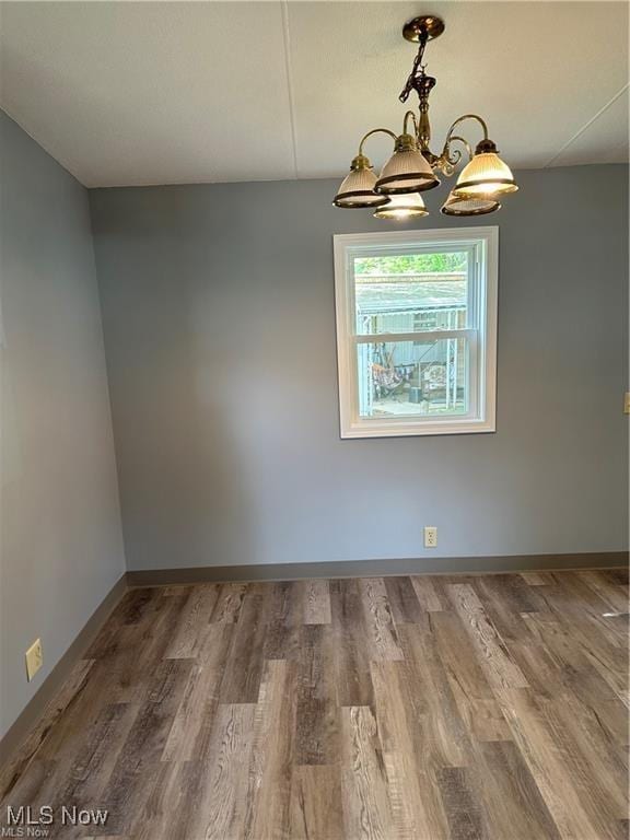 7443 Spillway Rd Unit 63, Lisbon, OH 44432 - unfurnished dining area with a chandelier and wood finished floors