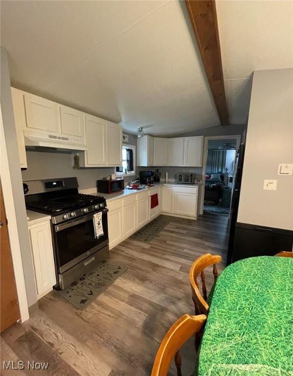 7443 Spillway Rd Unit 63, Lisbon, OH 44432 - kitchen with stainless steel gas range oven, under cabinet range hood, dark wood-style flooring, and white cabinets