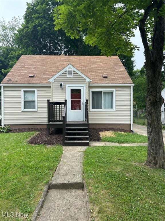 1042 Frederick Blvd, Akron, OH 44320 - bungalow-style house with a front lawn and roof with shingles