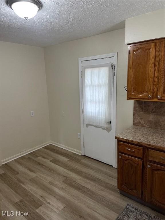1042 Frederick Blvd, Akron, OH 44320 - doorway to outside featuring light wood finished floors and a textured ceiling
