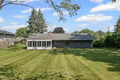 6265 Thunderbird Dr, Mentor, OH 44060 - back of property with a sunroom and a yard