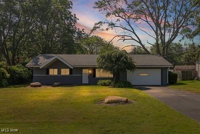 6265 Thunderbird Dr, Mentor, OH 44060 - view of front of property with driveway, a front lawn, and an attached garage
