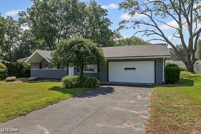 6265 Thunderbird Dr, Mentor, OH 44060 - ranch-style house featuring driveway, a garage, and a front lawn