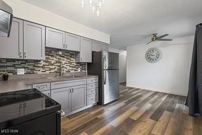 6265 Thunderbird Dr, Mentor, OH 44060 - kitchen with freestanding refrigerator, tasteful backsplash, ceiling fan, dark wood-style flooring, and black / electric stove