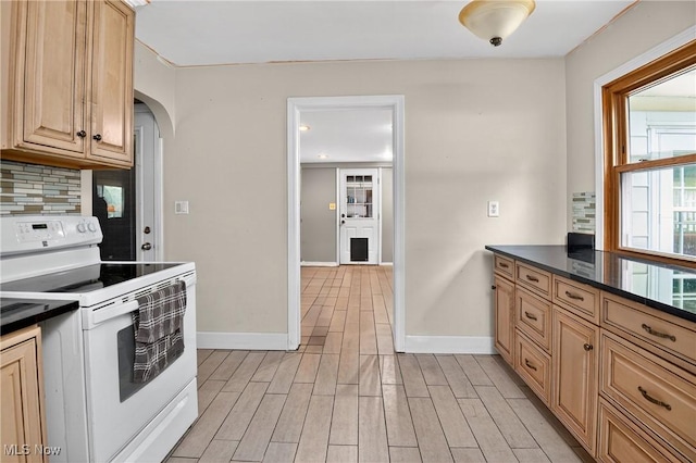 120 N Middle St, Columbiana, OH 44408 - kitchen with electric stove, decorative backsplash, dark countertops, arched walkways, and light wood finished floors