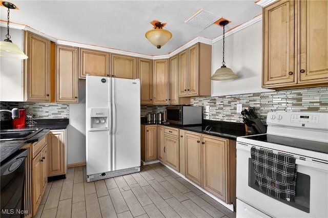 120 N Middle St, Columbiana, OH 44408 - kitchen featuring white appliances, dark countertops, tasteful backsplash, and hanging light fixtures