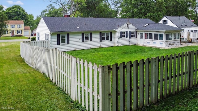 120 N Middle St, Columbiana, OH 44408 - view of front of house with a sunroom, a fenced backyard, a chimney, and roof with shingles