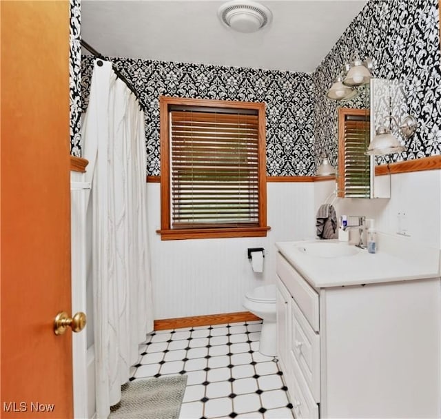 120 N Middle St, Columbiana, OH 44408 - bathroom with vanity, wallpapered walls, tile patterned floors, a wainscoted wall, and shower / bathtub combination with curtain