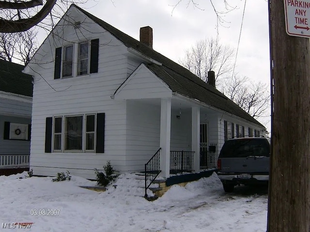 3858 E 53, Cleveland, OH 44105 - view of front of house with a chimney and a porch
