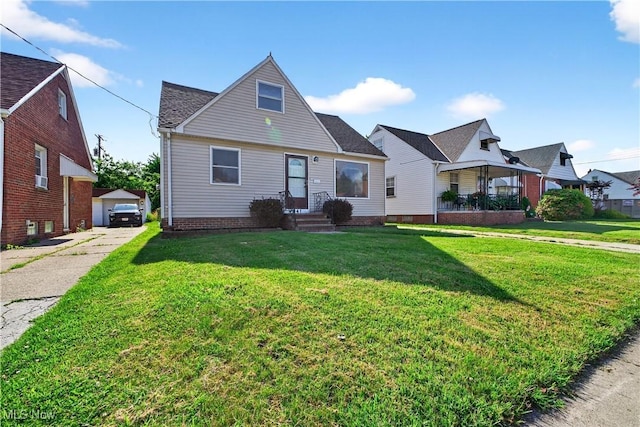 841 E 216th St, Euclid, OH 44119 - bungalow-style house with a front yard, entry steps, driveway, and a detached garage