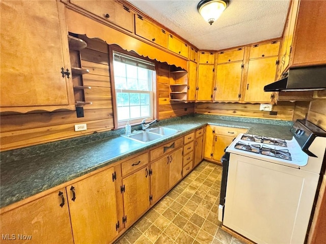33 Knight Ln, Big Bend, WV 26136 - kitchen with white range with gas cooktop, under cabinet range hood, a textured ceiling, and brown cabinets