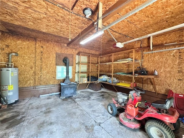 33 Knight Ln, Big Bend, WV 26136 - garage with gas water heater, a garage door opener, and a wood stove