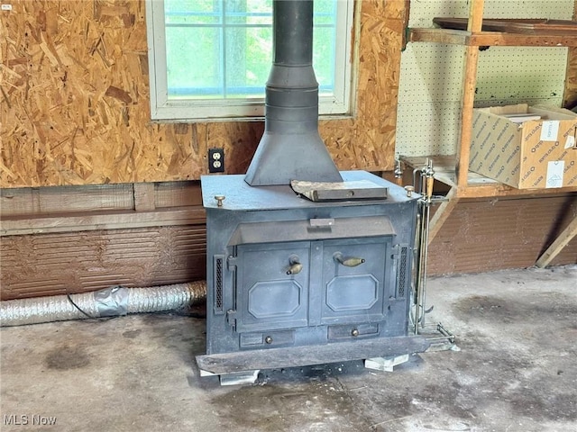 33 Knight Ln, Big Bend, WV 26136 - detailed view of a wood stove and unfinished concrete flooring