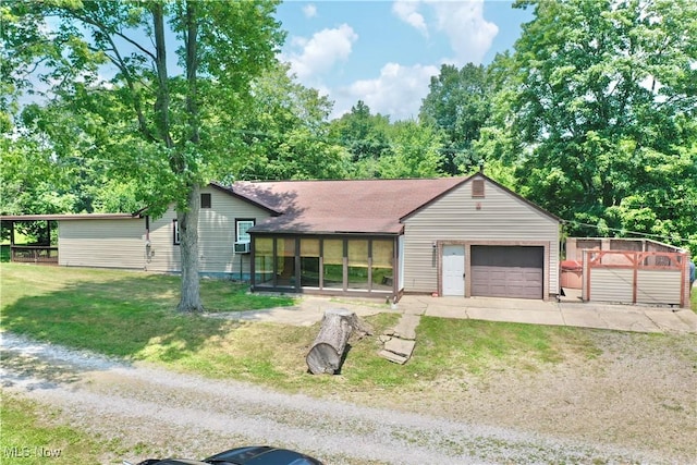 33 Knight Ln, Big Bend, WV 26136 - view of front of house with driveway, a garage, a front lawn, and a sunroom