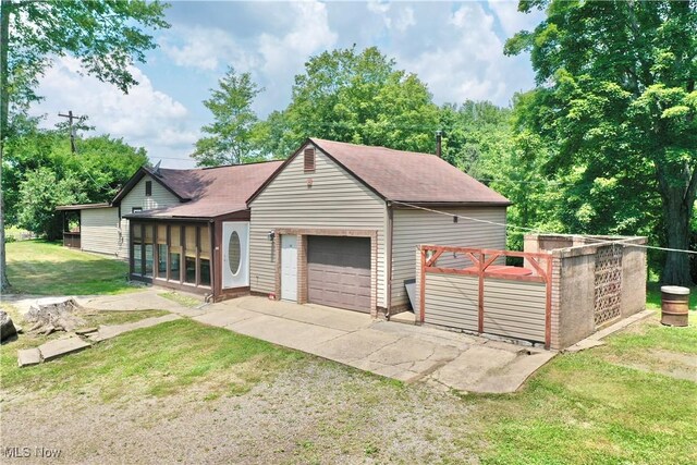 33 Knight Ln, Big Bend, WV 26136 - view of front of property featuring roof with shingles, a front lawn, driveway, and a sunroom