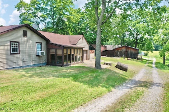 33 Knight Ln, Big Bend, WV 26136 - view of home's exterior with a sunroom, driveway, a lawn, cooling unit, and an attached garage