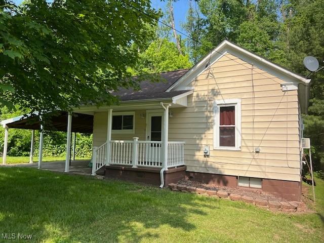 525 W 39th St, Shadyside, OH 43947 - rear view of house with a porch, a lawn, and roof with shingles