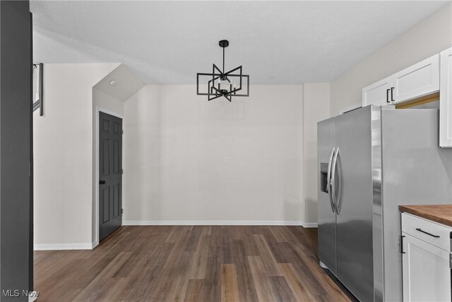 410 Elm St, Martins Ferry, OH 43935 - unfurnished dining area featuring dark wood-type flooring and a chandelier