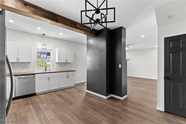 410 Elm St, Martins Ferry, OH 43935 - kitchen with stainless steel dishwasher, tasteful backsplash, white cabinetry, wood finished floors, and recessed lighting