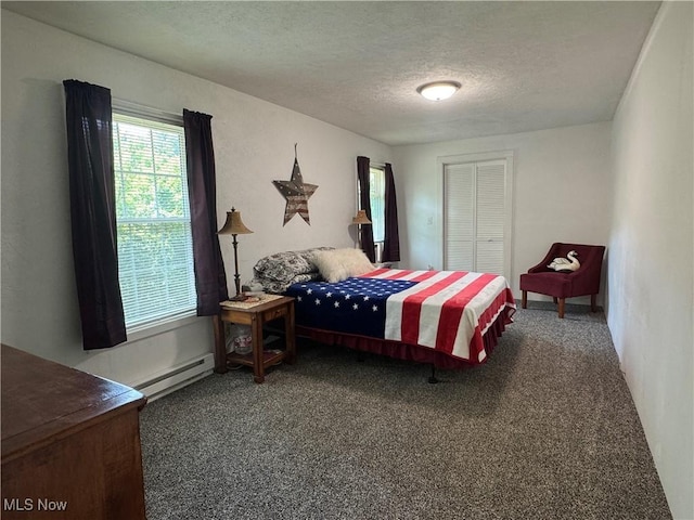 3028 Volcano Rd, Walker, WV 26180 - bedroom featuring a baseboard radiator, carpet flooring, a textured ceiling, and a closet