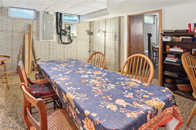 82 Pyle Rd, Oberlin, OH 44074 - dining space featuring electric panel, brick wall, and a drop ceiling