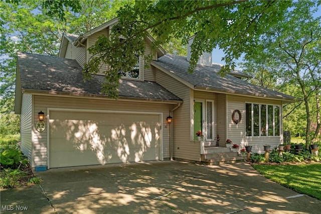 82 Pyle Rd, Oberlin, OH 44074 - view of front of house featuring driveway and a chimney