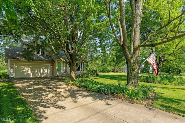 82 Pyle Rd, Oberlin, OH 44074 - view of front of home with driveway, a front yard, and view of wooded area