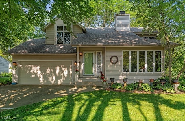 82 Pyle Rd, Oberlin, OH 44074 - view of front facade with an attached garage, concrete driveway, a front yard, a chimney, and a shingled roof