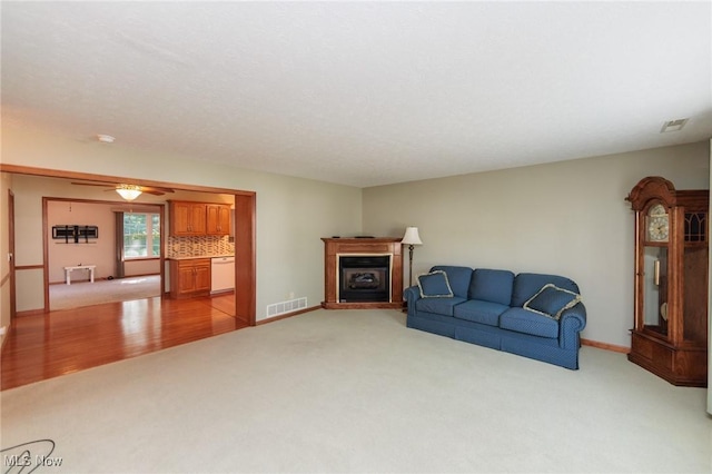 373 Chesapeake Cv, Painesville, OH 44077 - living area with light colored carpet, a fireplace, and ceiling fan