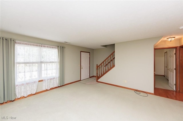 373 Chesapeake Cv, Painesville, OH 44077 - unfurnished living room featuring carpet floors and stairway