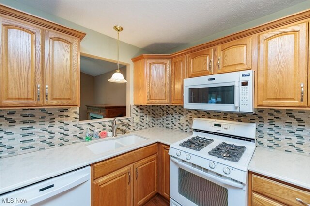373 Chesapeake Cv, Painesville, OH 44077 - kitchen featuring white appliances, backsplash, light countertops, and hanging light fixtures