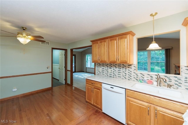 373 Chesapeake Cv, Painesville, OH 44077 - kitchen with white dishwasher, light wood finished floors, light countertops, backsplash, and ceiling fan
