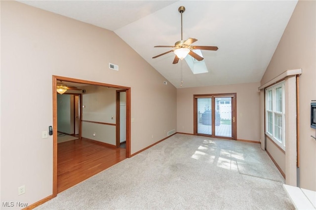 373 Chesapeake Cv, Painesville, OH 44077 - empty room with ceiling fan, lofted ceiling, light carpet, and a skylight