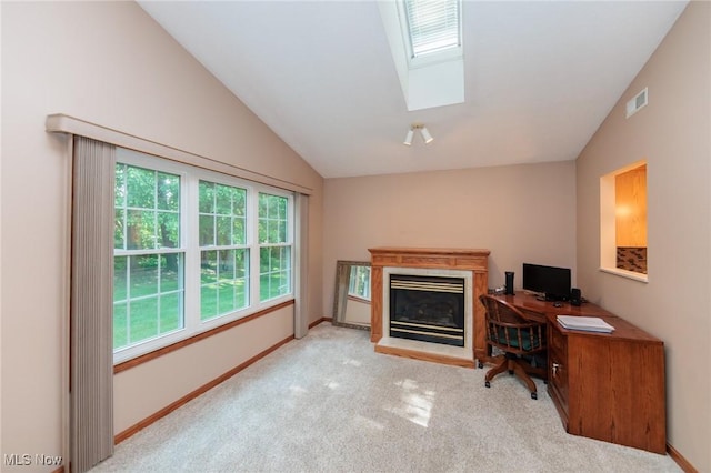 373 Chesapeake Cv, Painesville, OH 44077 - office area featuring vaulted ceiling, carpet floors, a skylight, and a glass covered fireplace