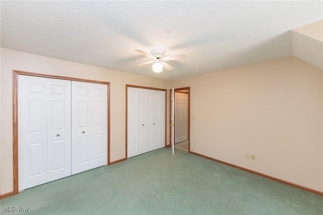 373 Chesapeake Cv, Painesville, OH 44077 - unfurnished bedroom featuring two closets, carpet flooring, and a ceiling fan