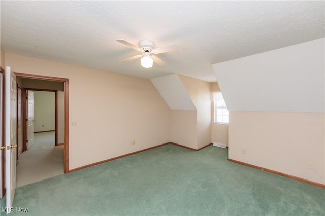 373 Chesapeake Cv, Painesville, OH 44077 - additional living space with carpet, a ceiling fan, a textured ceiling, and vaulted ceiling