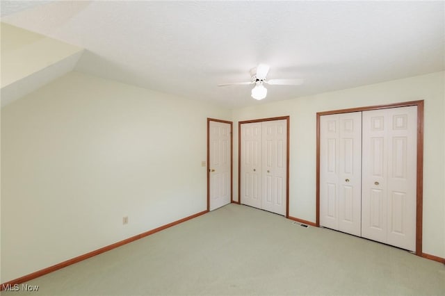 373 Chesapeake Cv, Painesville, OH 44077 - unfurnished bedroom with two closets, light carpet, and a ceiling fan