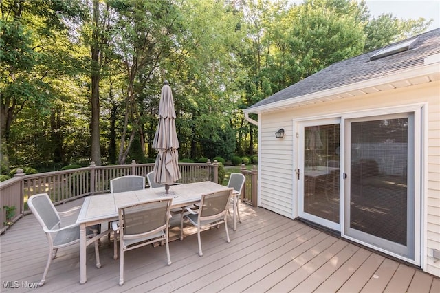 373 Chesapeake Cv, Painesville, OH 44077 - deck featuring outdoor dining area and view of scattered trees