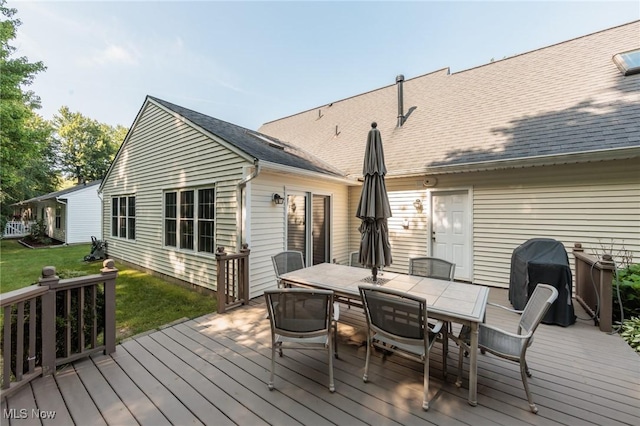 373 Chesapeake Cv, Painesville, OH 44077 - wooden terrace with area for grilling, outdoor dining area, and a lawn