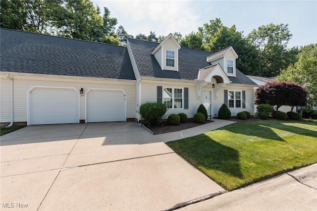 373 Chesapeake Cv, Painesville, OH 44077 - cape cod house with a garage, concrete driveway, a front lawn, and roof with shingles