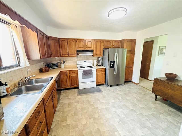 206 E 4th St, Williamstown, WV 26187 - kitchen featuring stainless steel appliances, under cabinet range hood, light countertops, and tasteful backsplash